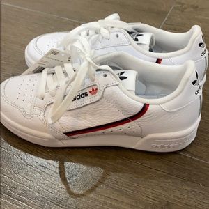 Adidas white sneakers.